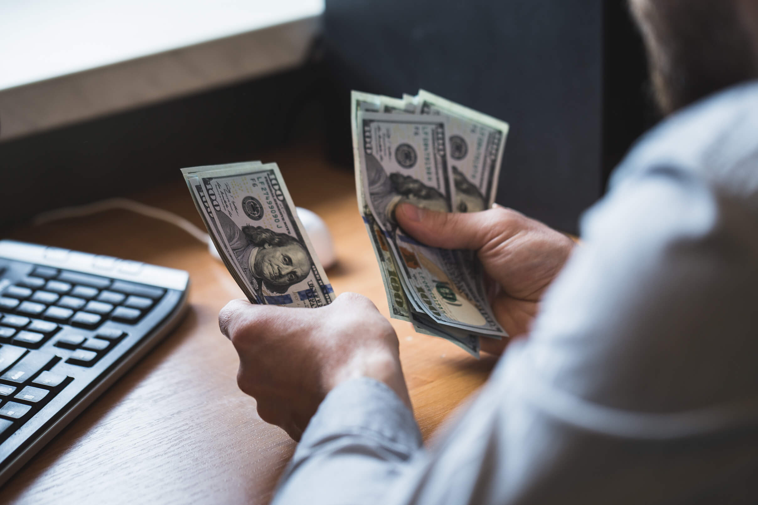 A person sorts dollar notes